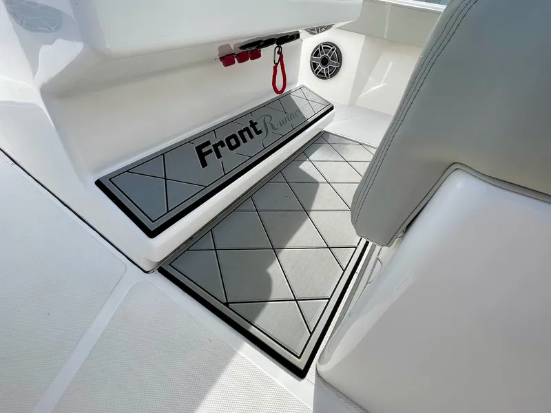 Slide: The Image of 2022 Front Runner 26 Center Console boat interior with custom flooring and speaker. - 24