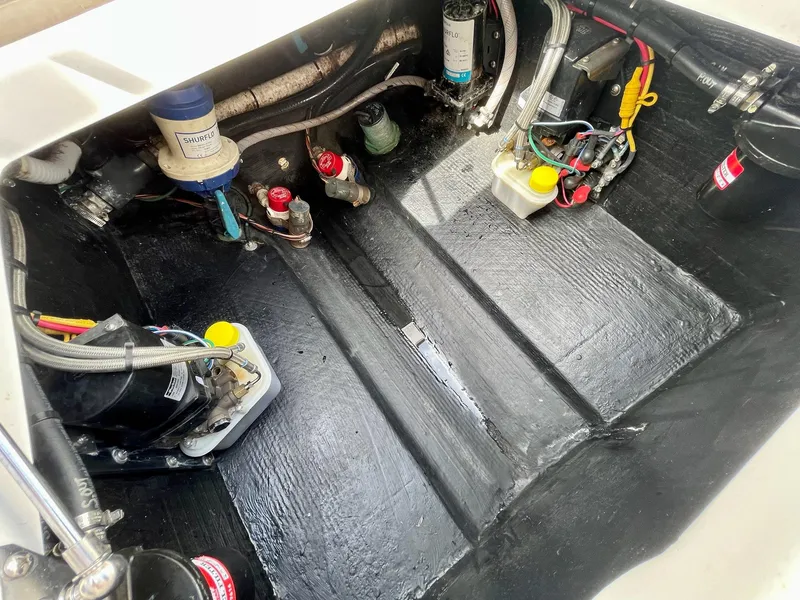 Slide: The Image of 2022 Front Runner 26 Center Console boat engine compartment with wiring and components. - 25