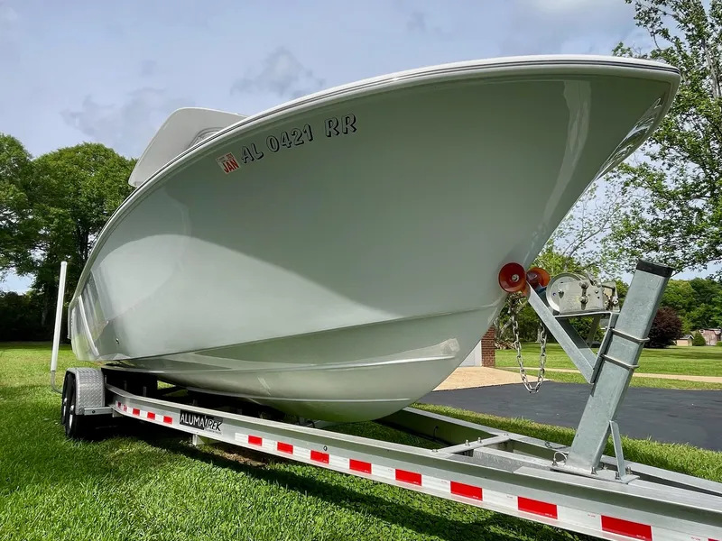 Slide: The Image of 2022 Front Runner 26 Center Console boat on trailer, parked on grass. - 3