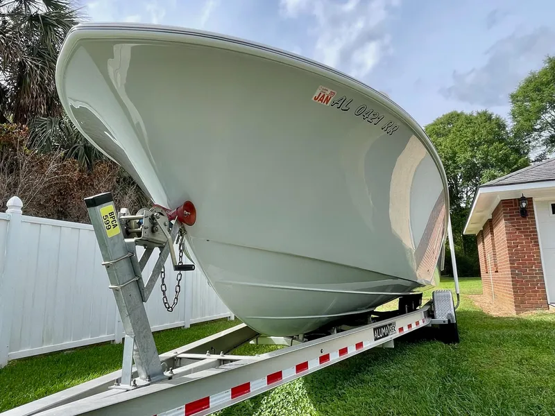 Slide: The Image of 2022 Front Runner 26 Center Console boat on trailer, parked in a grassy yard. - 4