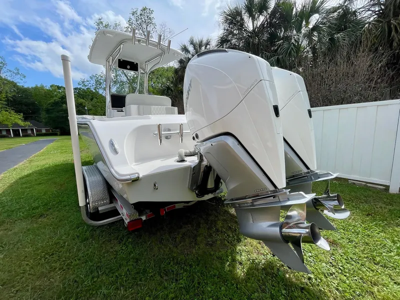 Slide: The Image of 2022 Front Runner 26 Center Console boat with dual outboard engines on a grassy lawn. - 6