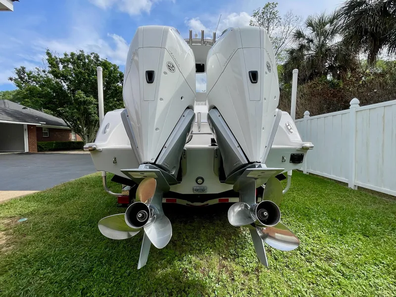 Slide: The Image of 2022 Front Runner 26 Center Console boat with dual outboard engines on grass. - 7