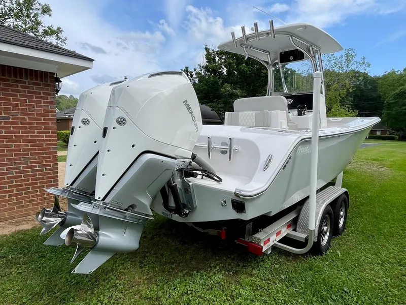 Slide: The Image of 2022 Front Runner 26 Center Console boat with dual outboard engines on a trailer. - 8