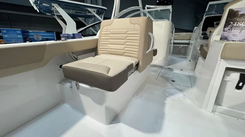 Slide: The Image of 2025 Edgewater 248 CX boat interior with beige seating and modern design. - 10