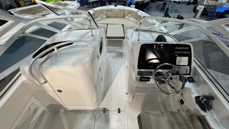 Slide: The Image of 2025 Edgewater 248 CX boat interior with modern dashboard and seating. - 11