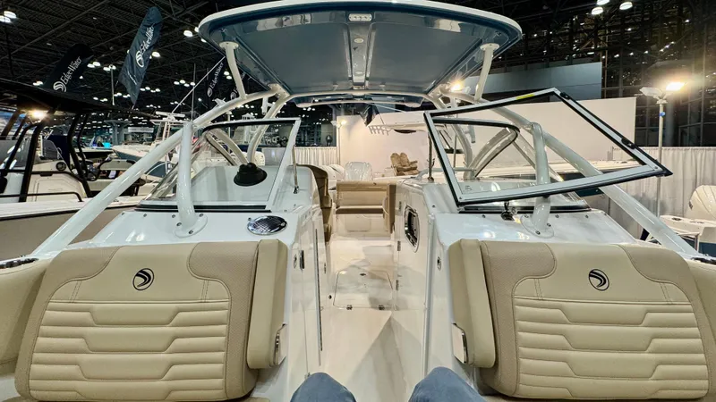 Slide: The Image of 2025 Edgewater 248 CX boat interior with beige seating and modern design. - 13