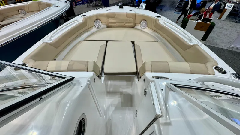 Slide: The Image of 2025 Edgewater 248 CX boat interior with beige seating and modern design. - 15