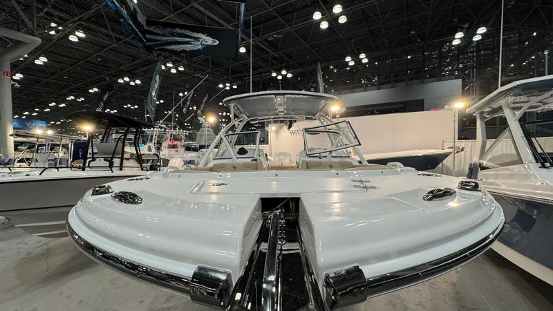 Slide: The Image of 2025 Edgewater 248 CX boat displayed at an indoor exhibition, showcasing sleek design and features. - 16