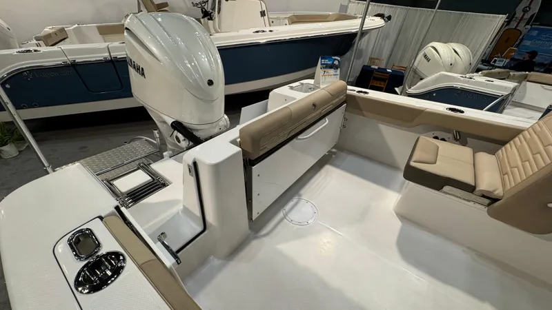 Slide: The Image of 2025 Edgewater 248 CX boat interior with seating and Yamaha outboard motor. - 4
