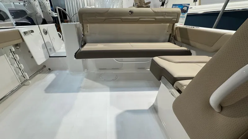 Slide: The Image of 2025 Edgewater 248 CX boat interior with beige seating and modern design. - 5