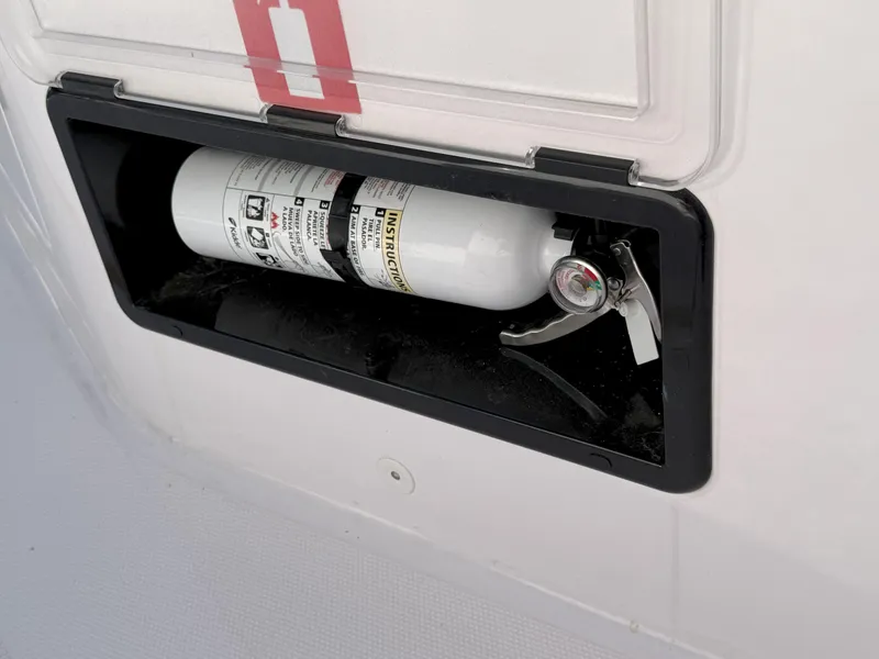 Slide: The Image of Fire extinguisher compartment on 2024 Axopar Cross Cabin boat. - 21