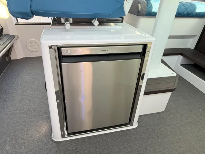 Slide: The Image of Compact stainless steel fridge in 2024 Axopar Cross Cabin boat interior. - 42