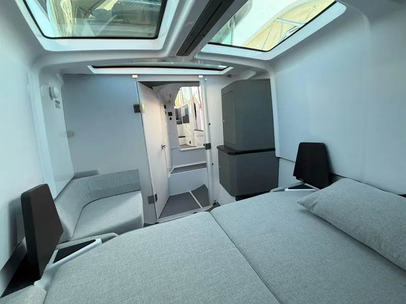 Slide: The Image of 2024 Axopar Cross Cabin interior with modern design, skylights, and comfortable seating. - 46