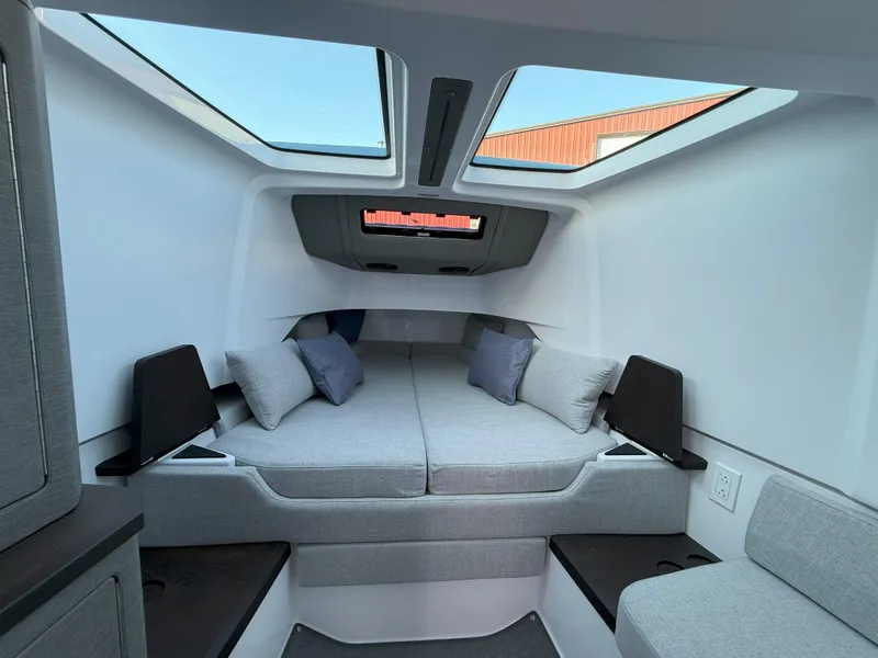 Slide: The Image of 2024 Axopar Cross Cabin interior with skylights, modern design, and comfortable seating. - 48