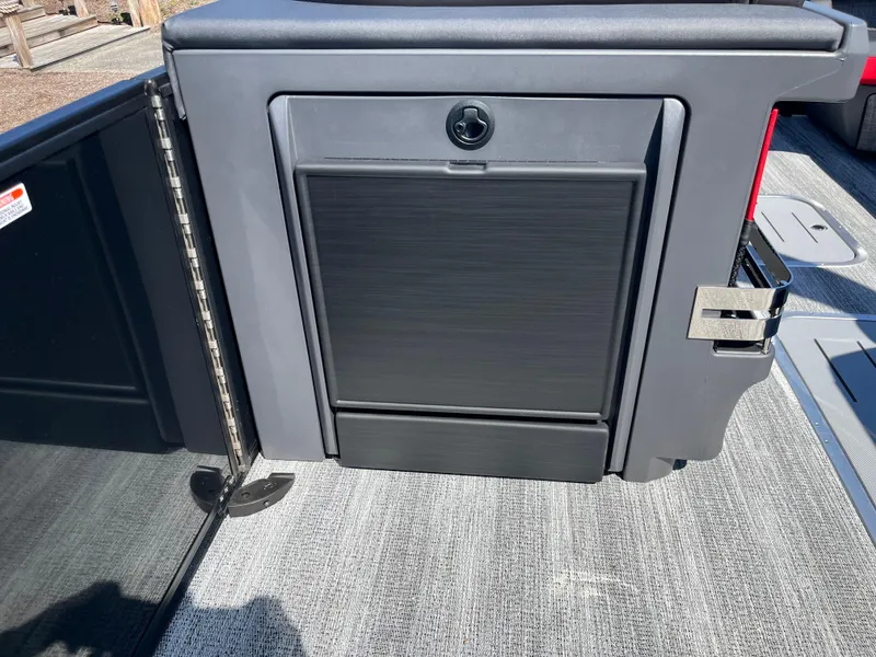 Slide: The Image of 2025 Bennington M Line boat storage compartment with sleek black finish. - 16