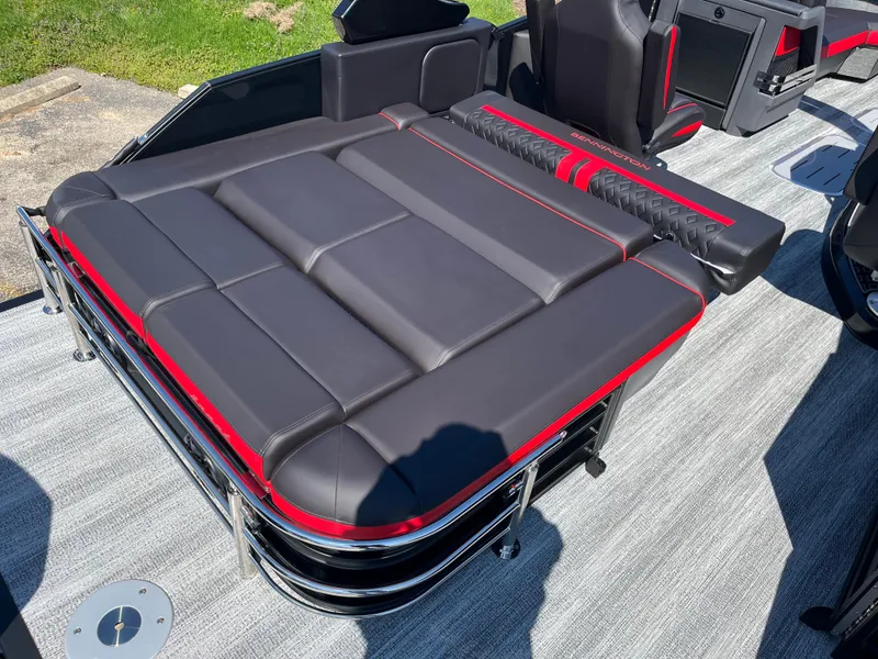 Slide: The Image of 2025 Bennington M Line boat interior with sleek black and red seating. - 22