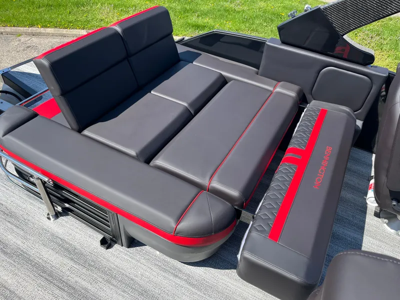 Slide: The Image of 2025 Bennington M Line boat seating with sleek black and red upholstery. - 23