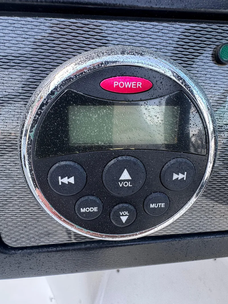 Slide: The Image of Close-up of a 2014 Sea Ray 260 Sundeck audio control panel with buttons and display. - 11