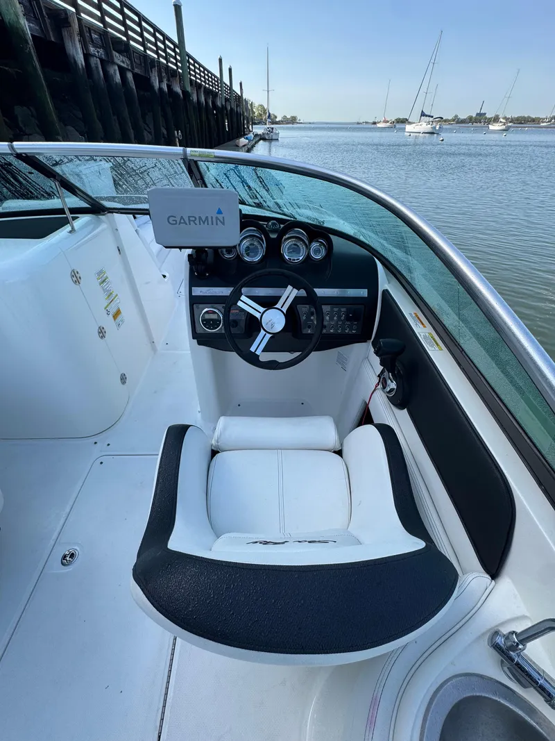 Slide: The Image of Cockpit of 2014 Sea Ray 260 Sundeck with Garmin navigation, docked by calm waters. - 14