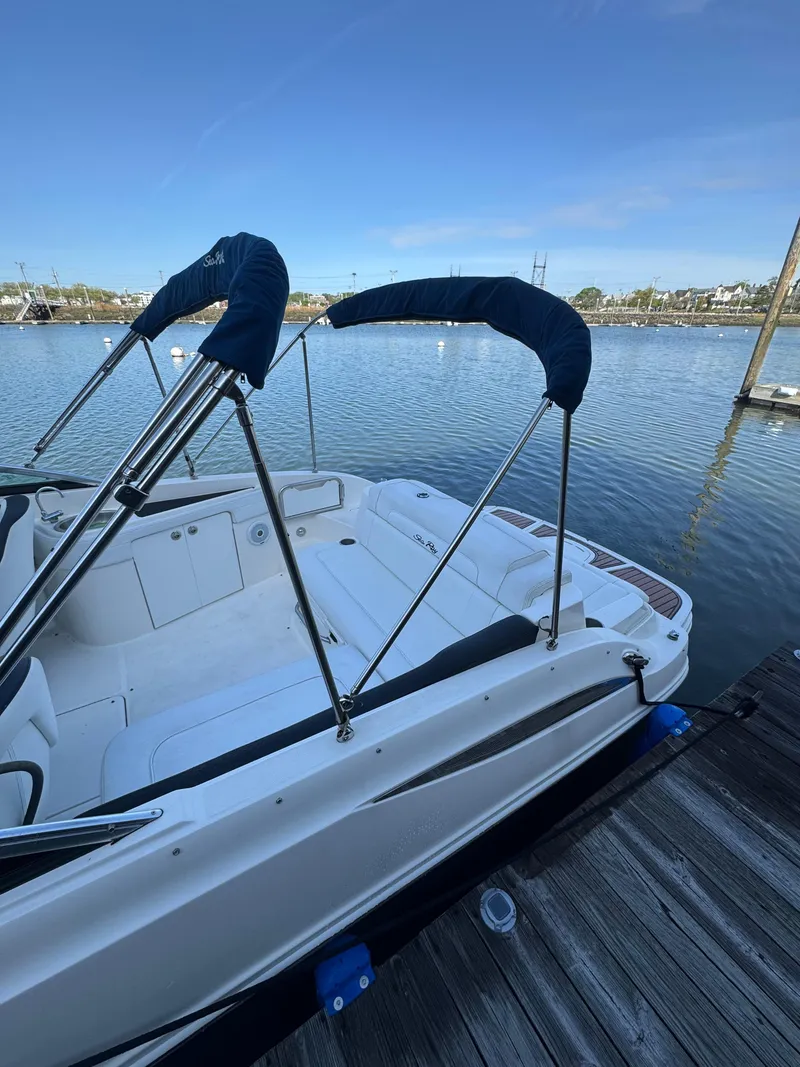 Slide: The Image of 2014 Sea Ray 260 Sundeck boat docked by calm waters. - 5