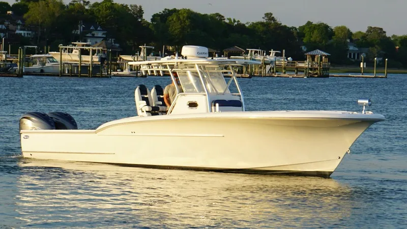 Slide: The Image of 2013 Buddy Davis 34 Center Console boat on calm water, with scenic background. - 11