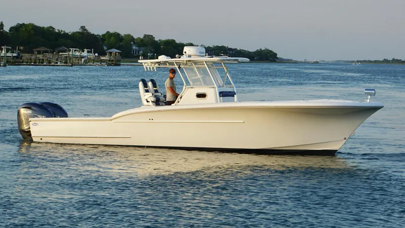 Slide: The Image of 2013 Buddy Davis 34 Center Console boat on calm water. - 13