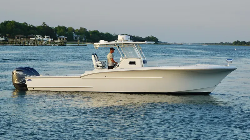 Slide: The Image of 2013 Buddy Davis 34 Center Console boat on calm water, side view. - 14