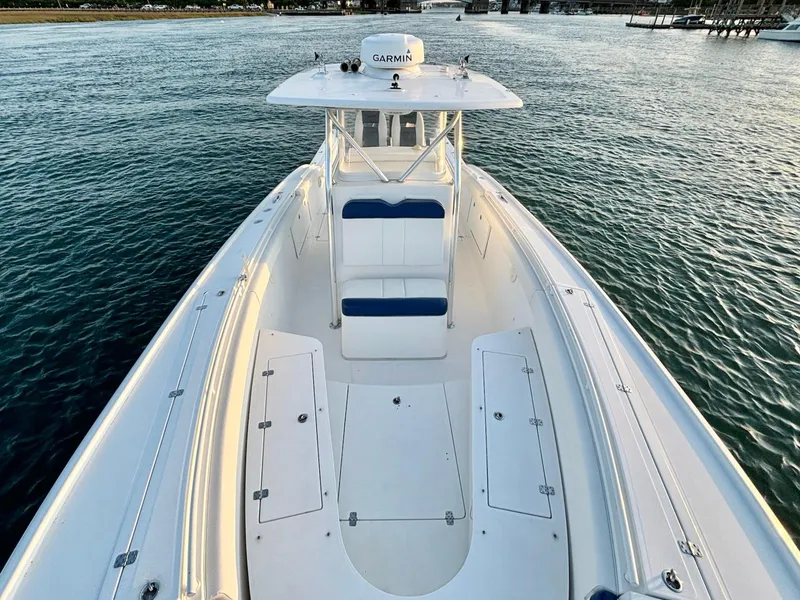 Slide: The Image of 2013 Buddy Davis 34 Center Console boat on water, featuring spacious deck and Garmin equipment. - 17