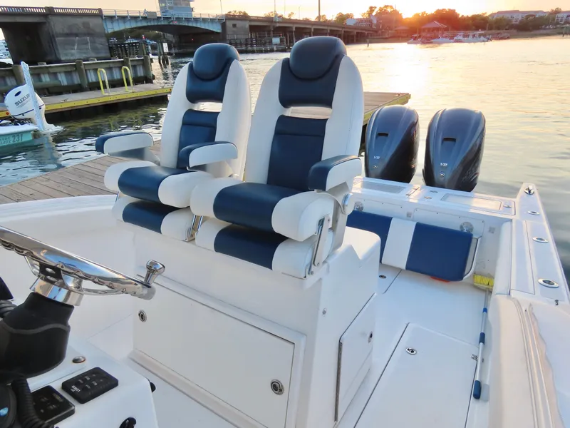Slide: The Image of 2013 Buddy Davis 34 Center Console boat with dual seats and twin engines at sunset. - 18