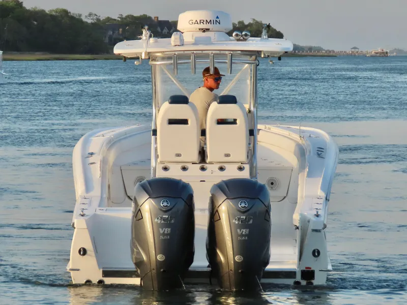 Slide: The Image of 2013 Buddy Davis 34 Center Console boat with dual engines on calm water. - 3