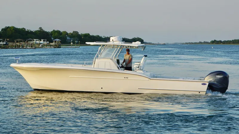 Slide: The Image of 2013 Buddy Davis 34 Center Console boat cruising on a calm waterway. - 4