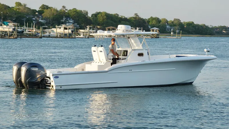 Slide: The Image of 2013 Buddy Davis 34 Center Console boat on calm water with twin Yamaha engines. - 7