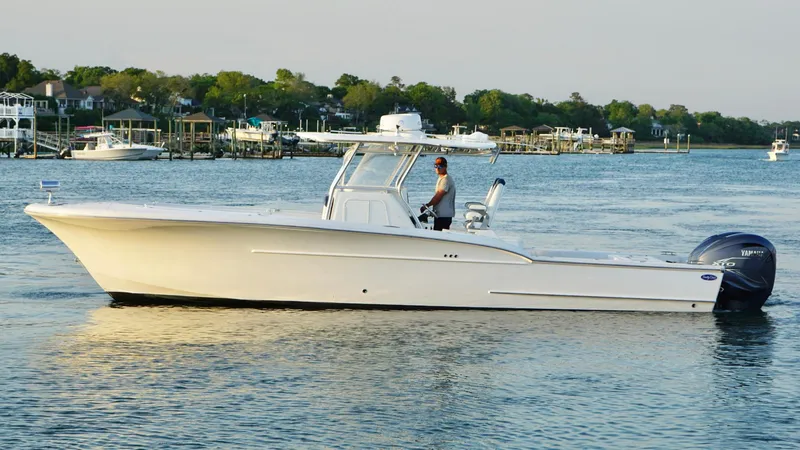 Slide: The Image of 2013 Buddy Davis 34 Center Console boat cruising on a calm waterway. - 8