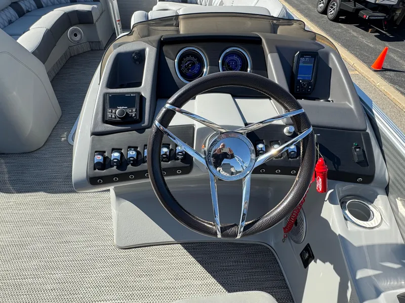 Slide: The Image of 2020 Bennington Q 25 QSR boat dashboard with steering wheel and control panel. - 12