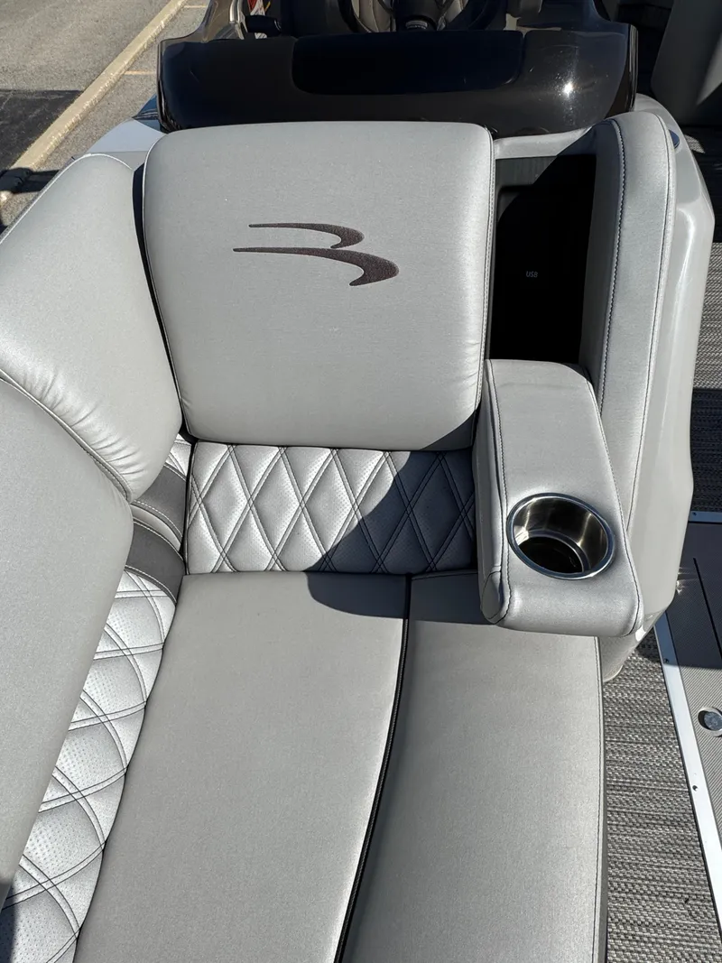 Slide: The Image of 2020 Bennington Q 25 QSR boat seat with gray upholstery and cup holder. - 18