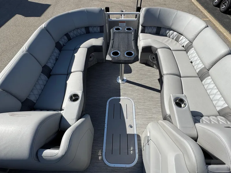 Slide: The Image of 2020 Bennington Q 25 QSR pontoon boat interior with gray seating and central table. - 19