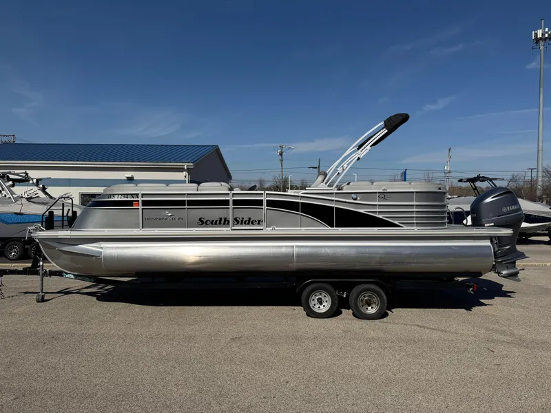 Slide: The Image of 2020 Bennington Q 25 QSR pontoon boat on trailer, parked outdoors. - 2