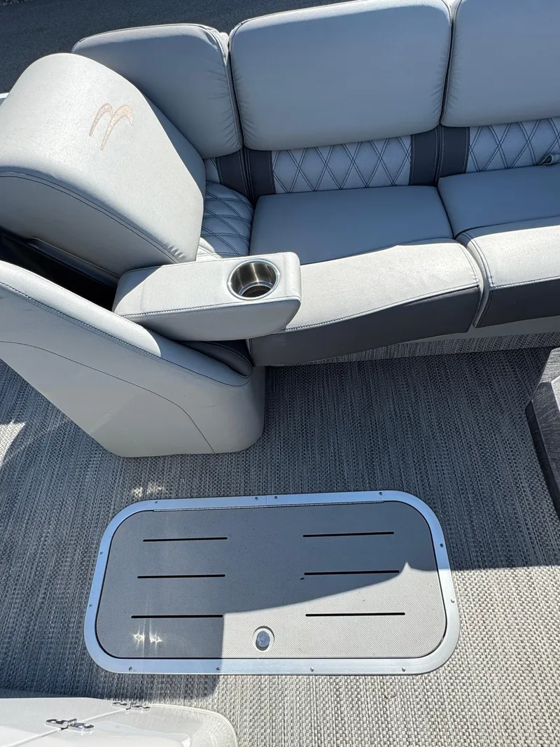 Slide: The Image of 2020 Bennington Q 25 QSR boat interior with gray seating and cup holder. - 24