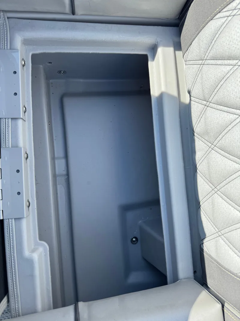 Slide: The Image of Storage compartment in a 2020 Bennington Q 25 QSR boat, featuring quilted upholstery. - 26