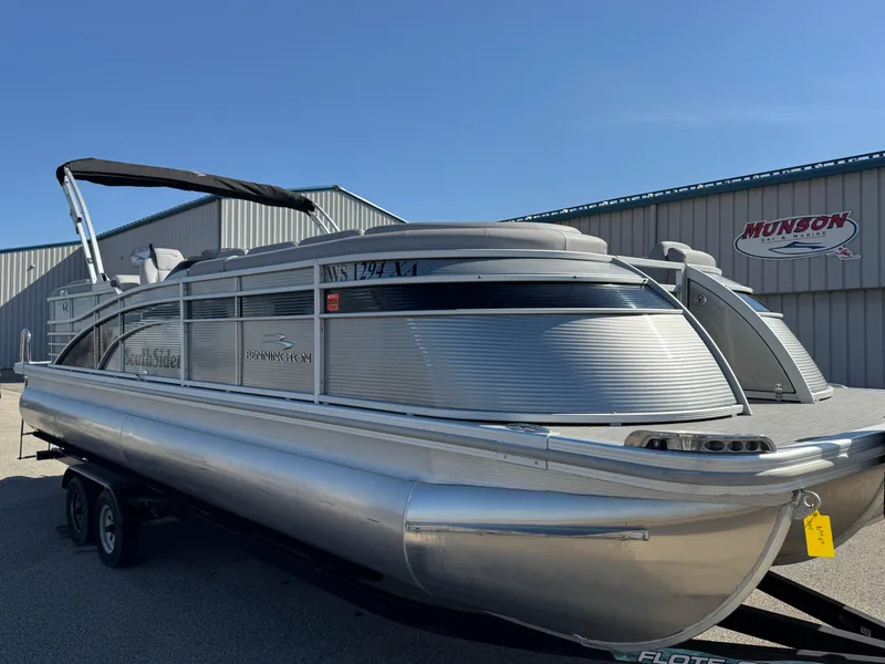 Slide: The Image of 2020 Bennington Q 25 QSR pontoon boat parked outdoors near a warehouse. - 7