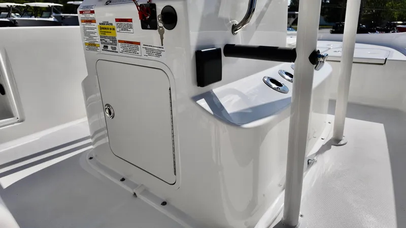 Slide: The Image of 2025 Bayliner T18 Limited Edition boat console with storage compartment and controls. - 1