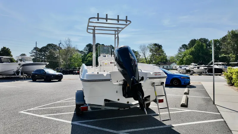 Slide: The Image of Bayliner T18 Limited Edition 2025 boat parked in a lot, rear view with motor and ladder. - 15