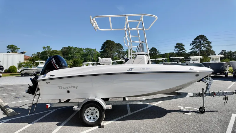 Slide: The Image of 2025 Bayliner T18 Limited Edition boat on trailer, parked outdoors under clear sky. - 16