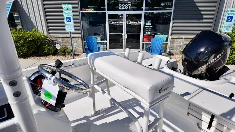 Slide: The Image of 2025 Bayliner T18 Limited Edition boat interior with steering wheel and seating, outside a dealership. - 5
