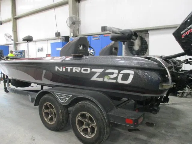 Slide: The Image of 2023 Nitro Z20 boat on trailer in a garage setting. - 13