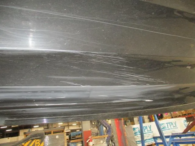 Slide: The Image of 2023 Nitro Z20 boat hull with visible scratches in a workshop setting. - 17