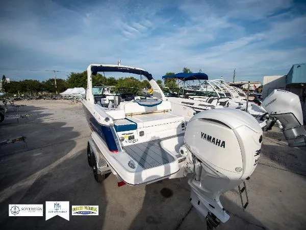 Slide: The Image of 2024 Chaparral 270 OSX boat with Yamaha engine, docked outdoors under a clear sky. - 13