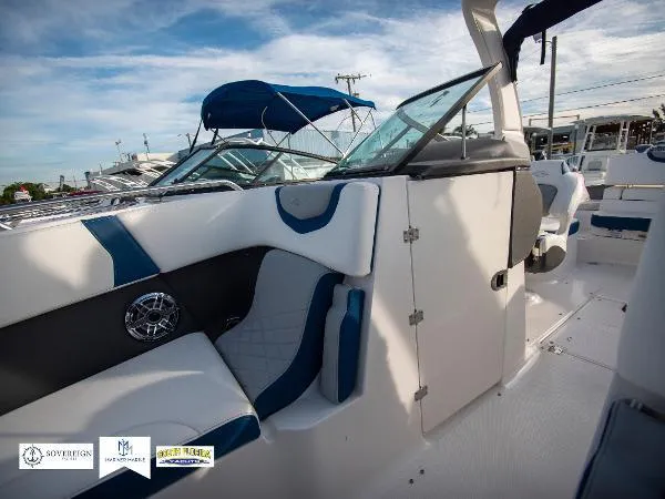 Slide: The Image of 2024 Chaparral 270 OSX boat interior with blue and white seating, showcasing modern design. - 17
