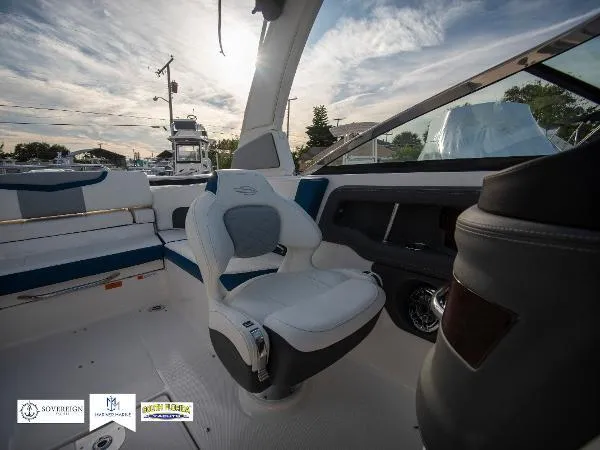 Slide: The Image of 2024 Chaparral 270 OSX boat interior with modern seating and dashboard. - 19