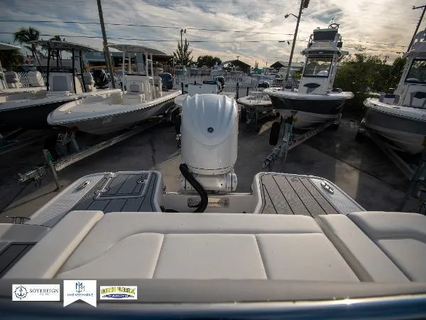 Slide: The Image of 2024 Chaparral 270 OSX boat in a marina, surrounded by other boats. - 22